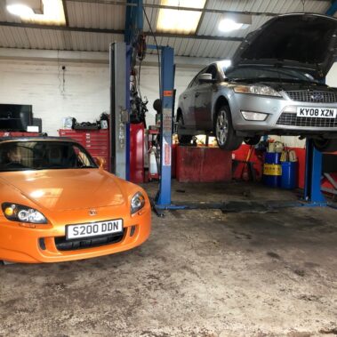 Mechanic inspecting worn brake pads during brake repair in Worcester