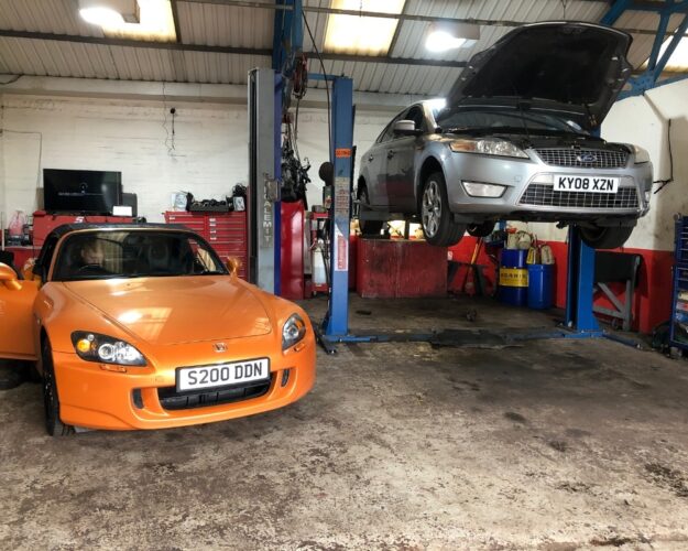 Mechanic inspecting worn brake pads during brake repair in Worcester Mechanic inspecting worn brake pads during brake repair in Worcester