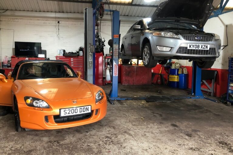 Mechanic inspecting worn brake pads during brake repair in Worcester
